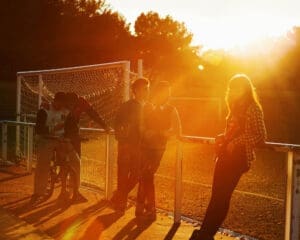 http://Kids,%20teenagers,%20young%20people,%20hanging%20out,%20gathering,%20socialising,%20group,%20football%20pitch,%20sunset,%20golden%20hour,%20Bacau,%20Romania