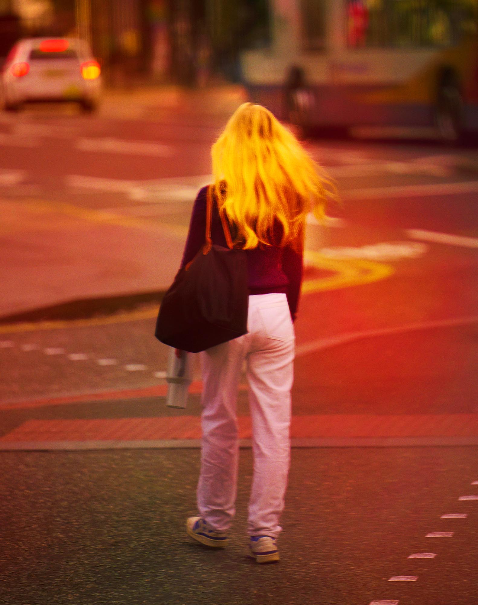 Evocative street portrait with golden light on a woman's hair on streets of Manchester by British photographer Ben Stockley.